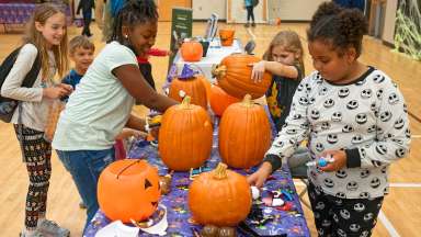 children enjoying pumpkins at a fall festival