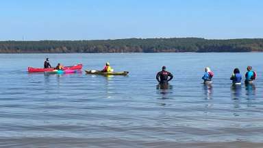 people paddling in cold water