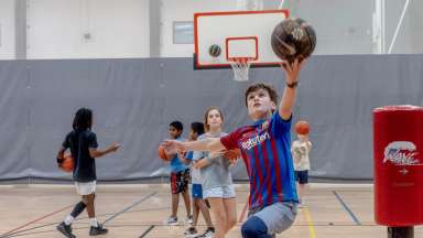 teen doing a lay up