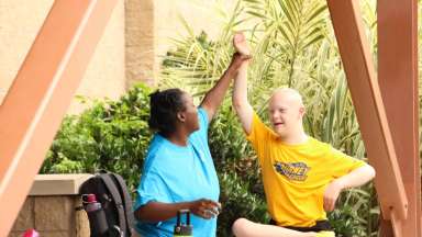 counselor and kid high fiving