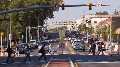 This shows people walking and driving along Hillsborough Street.