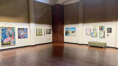 Gallery with framed artwork on the wall.