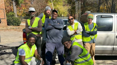 Workforce members pose in safety gear