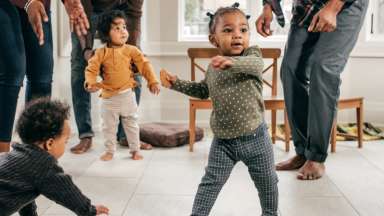 young child dancing with peers