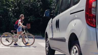 girl crossing the street with bike