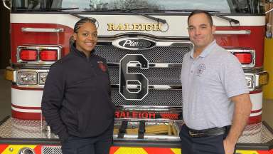 Benvenuto and Rountree pose in front of fire engine number 6