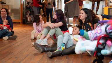 families smiling sitting at the city of Raleigh museum