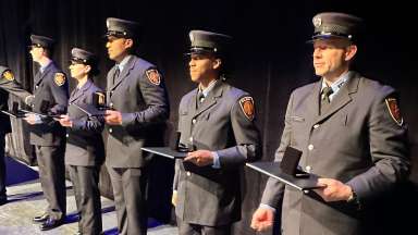 Raleigh Fire personnel in formal uniform are standing holding awards