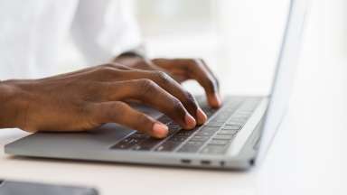 Close up of a person typing on a keyboard
