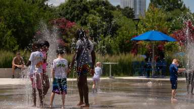 kids in a sprinkler at the park