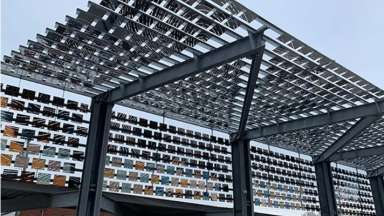 Reflective metal squares covering an angled outdoor canopy.