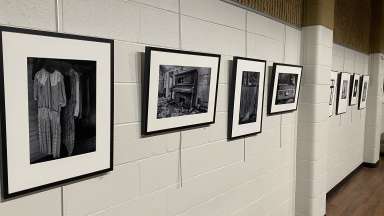 black and white photographs hanging on a white wall