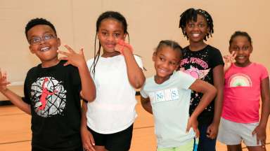 children smiling in a gym