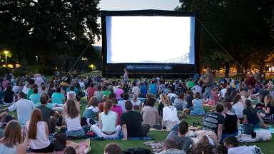 people on the lawn watching movie