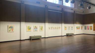 colorful paintings by Dain Kim hanging in a large room