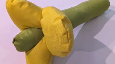 Puffy hand sewn lupine flower made with green and yellow fabric.
