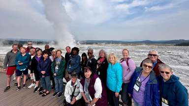 group of people at a geyser