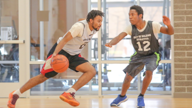 two adults playing basketball