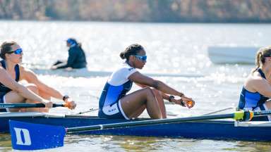 three rowers on a boat at lake wheeler