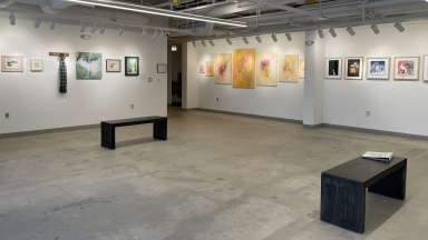 Painting and artwork hang on the walls of Pullen's main gallery