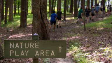 a sign with a trail in the background