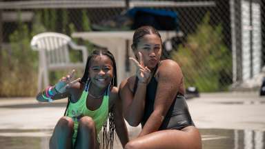 two people posing near the pool at camp