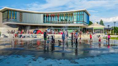 the exterior of Chavis park with children playing in the splashpad