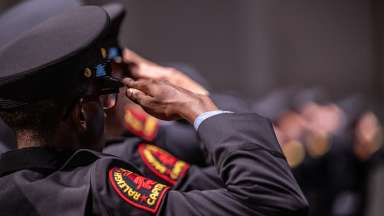 A close up shot from behind of a Raleigh Police Officer saluting