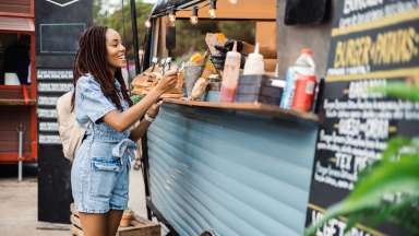 a person buying food from a food truck