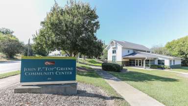 an image of the old sign and current building of the John P. “Top” Greene African American Cultural Center