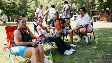 an image of people sitting in lawn chairs at Dix and one is holding a baby