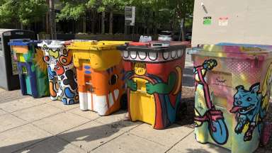 colorful rolling trash bins painted by artists.