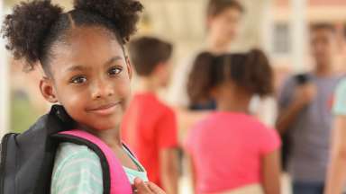 a child with a backpack on getting ready to go back to school