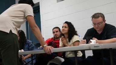 an image of person speaking in front a class