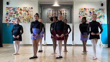 in a dance studio - eight girls in two lines facing the camera