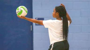 a volleyball player preparing to serve the ball