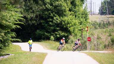 image of two bikes and runner on greenway