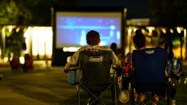 a movie showing on a lawn park