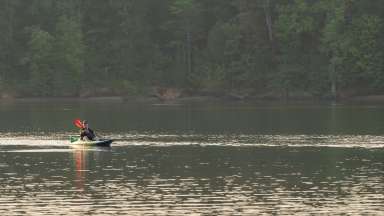 a person on Falls Lake enjoying a paddling on a kayak