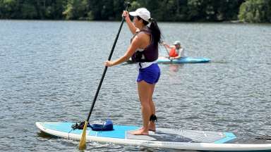 a person paddleboarding on a lake