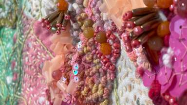embroidered artwork with beads and sequins, in pinks, greens, reds and peaches and creams by Patrizia Ferreira