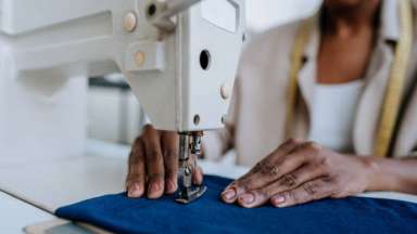 a person using a sewing machine