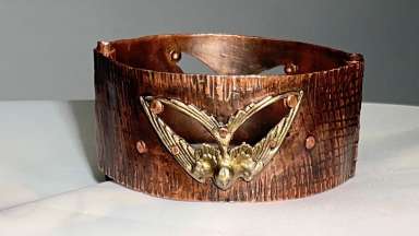 Metal bracelet with hinges and cut out shapes