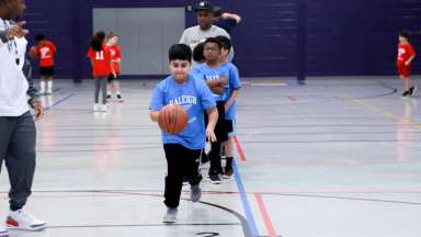 a boy practicing basketball