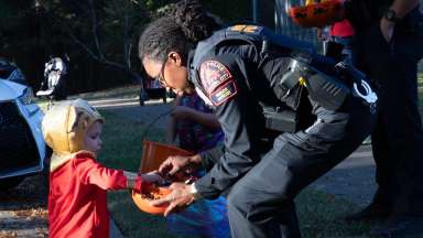a kid in costume doing trunk or treat