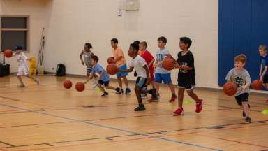 kids playing basketball and running drill