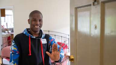 resident waving in doorway