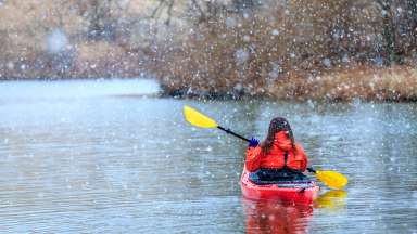 a kayaker on the lake in the snow