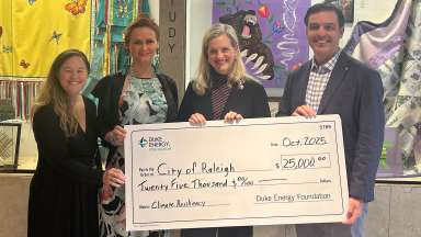 Mary Alice Holley, Megan Anderson, Mayor Cowell, and Remer hold Duke Energy check for $25,000