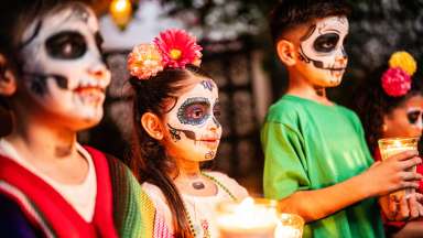 kids celebrating with their face painted day of the dead